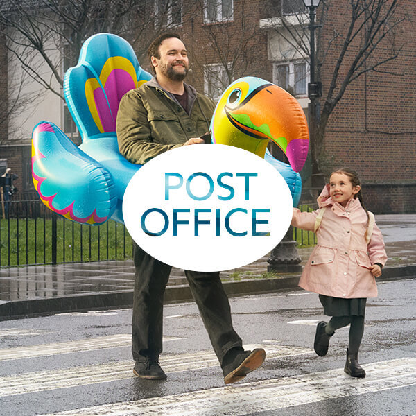 Post Office Logo With A Man Wearing An Inflatable Tocan And A Little Girl